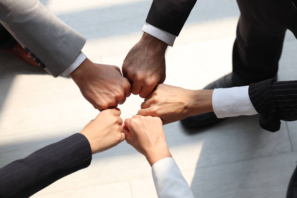 stock-photo-overhead-view-businessman-woman-putting-hands-first-join-together-business.jpg